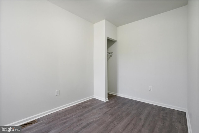 517 N 64th St, Philadelphia, PA 19151 - unfurnished bedroom featuring a closet, baseboards, dark wood-style floors, and visible vents