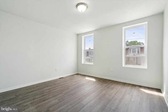 517 N 64th St, Philadelphia, PA 19151 - spare room with baseboards, dark wood-style floors, and visible vents