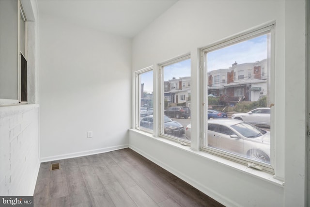 517 N 64th St, Philadelphia, PA 19151 - unfurnished dining area with visible vents, baseboards, wood finished floors, and a healthy amount of sunlight