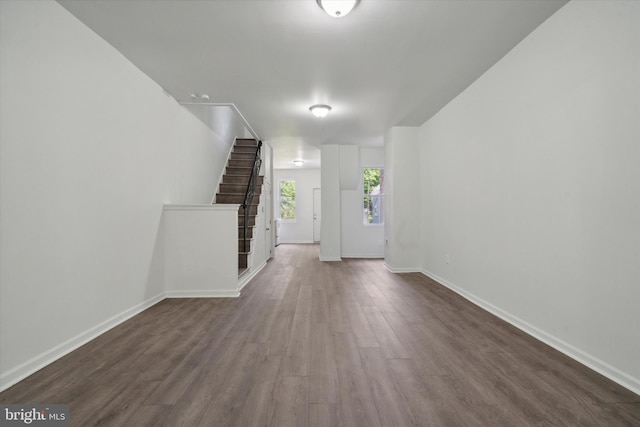 517 N 64th St, Philadelphia, PA 19151 - unfurnished living room with stairs, dark wood-style floors, and baseboards