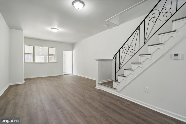 517 N 64th St, Philadelphia, PA 19151 - unfurnished living room featuring dark wood-type flooring, baseboards, and stairway