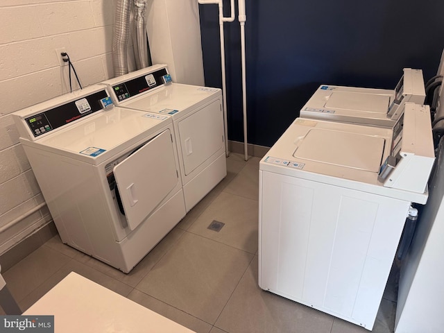 6100 Henry Ave Unit 7D, Philadelphia, PA 19128 - community laundry room featuring independent washer and dryer, concrete block wall, and light tile patterned flooring