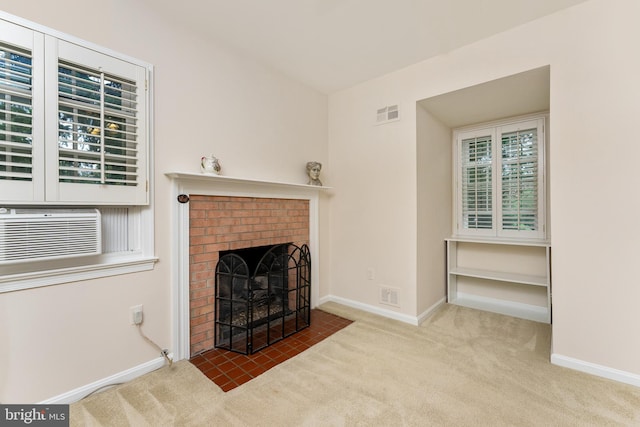 unfurnished living room featuring carpet floors, baseboards, a fireplace, cooling unit, and healthy amount of natural light