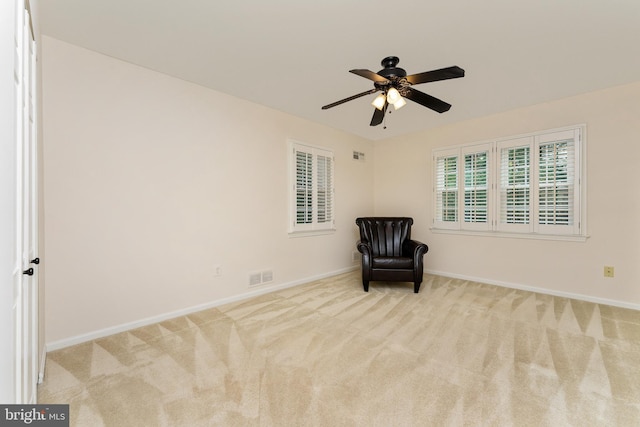 unfurnished room featuring carpet floors, a ceiling fan, and baseboards