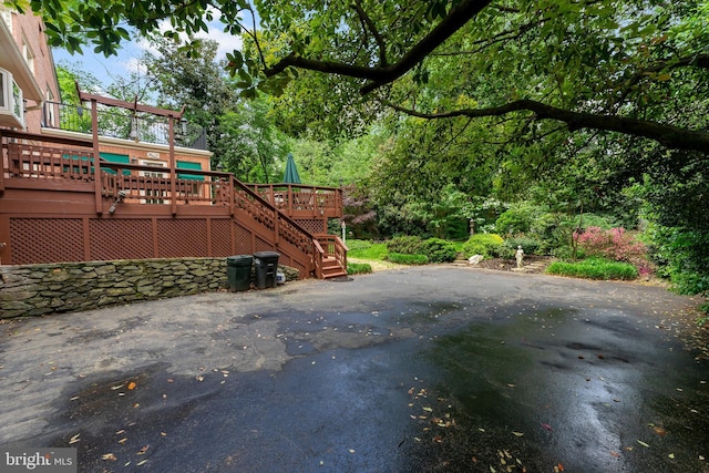 gate featuring a deck, stairway, and a patio area
