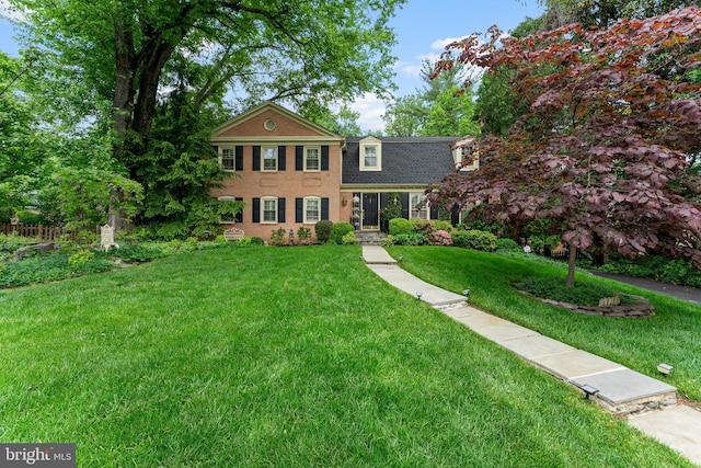 view of front of property with a front yard and brick siding