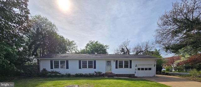 single story home featuring a front lawn, driveway, and a garage