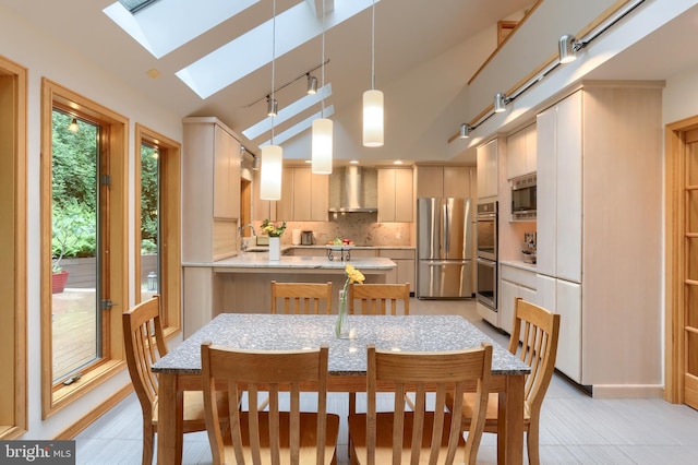 1023 Fairdell Dr, Hummelstown, PA 17036 - kitchen with appliances with stainless steel finishes, wall chimney exhaust hood, a skylight, decorative backsplash, and a peninsula