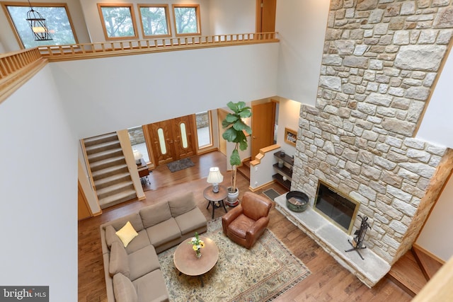 1023 Fairdell Dr, Hummelstown, PA 17036 - living area with wood finished floors, a towering ceiling, stairway, and a fireplace