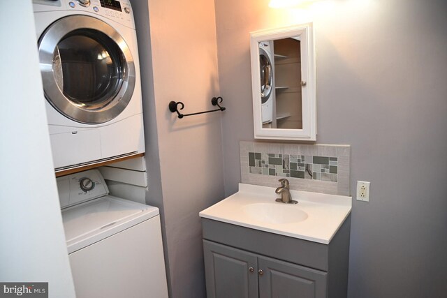 885 N York Rd Unit 12C, Warminster, PA 18974 - bathroom featuring vanity, stacked washer / dryer, and tasteful backsplash