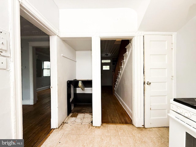 hall featuring stairway, light wood-style floors, and baseboards