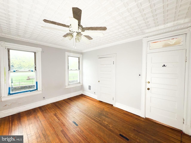 spare room featuring baseboards, plenty of natural light, and hardwood / wood-style flooring