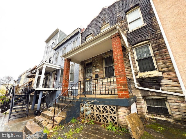 view of front facade with a porch and stone siding