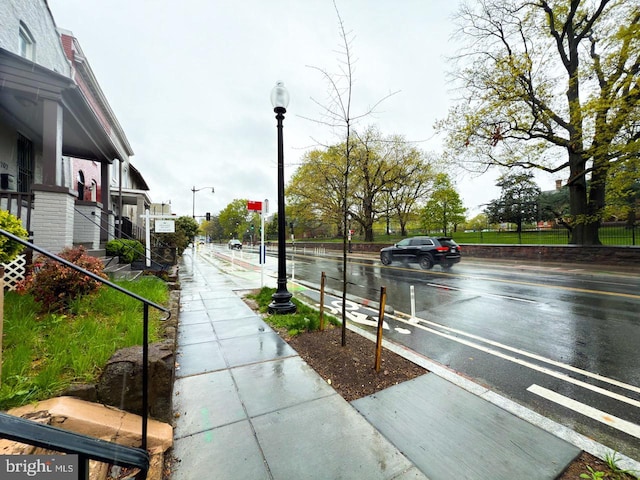 view of road with sidewalks and street lighting