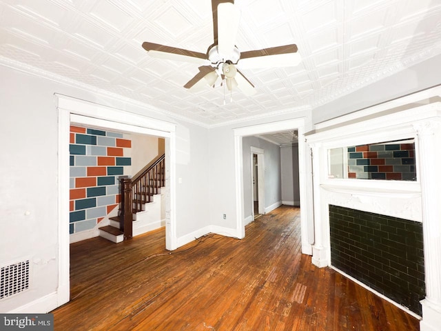 unfurnished living room with a ceiling fan, visible vents, stairs, wood-type flooring, and baseboards