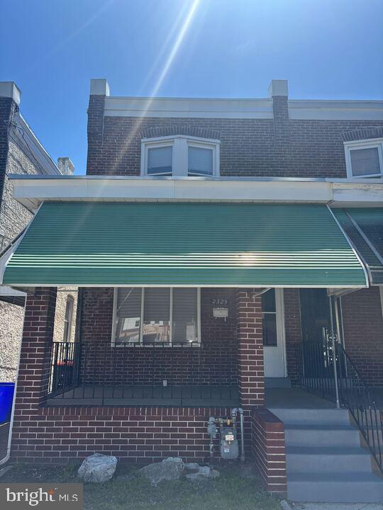 2325 W 4th St, Chester, PA 19013 - view of front of property with covered porch and brick siding