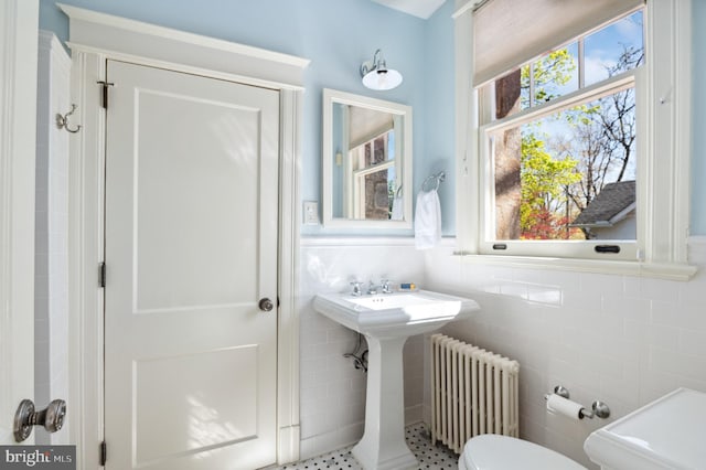 3712 Bradley Ln, Chevy Chase, MD 20815 - bathroom with radiator heating unit, tile walls, and toilet