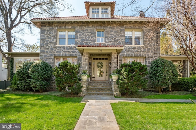 3712 Bradley Ln, Chevy Chase, MD 20815 - view of front of property with stone siding, a front yard, and a chimney