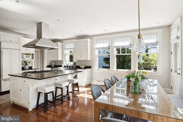 3712 Bradley Ln, Chevy Chase, MD 20815 - kitchen featuring island range hood, dark countertops, white cabinetry, and recessed lighting