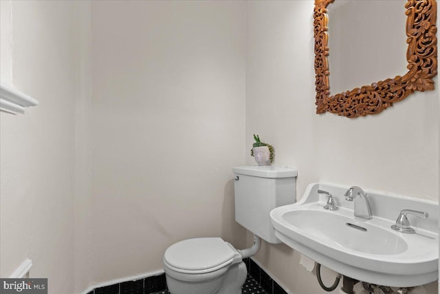 3721 Massachusetts Ave NW, Washington, DC 20016 - half bathroom with toilet, a sink, and tile patterned flooring