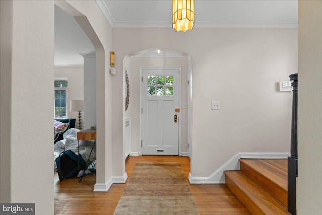 3721 Massachusetts Ave NW, Washington, DC 20016 - foyer with crown molding, wood finished floors, arched walkways, and baseboards