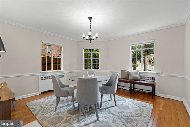 3721 Massachusetts Ave NW, Washington, DC 20016 - dining space featuring radiator, a chandelier, ornamental molding, wood finished floors, and baseboards