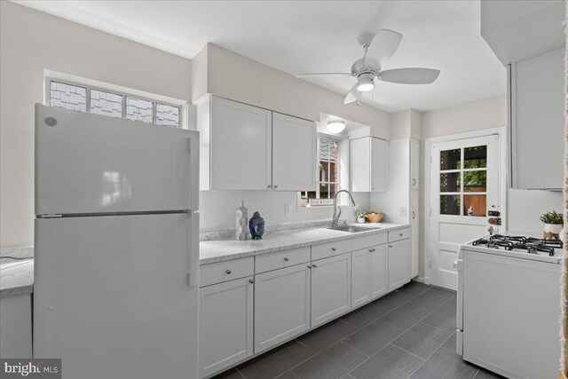 3721 Massachusetts Ave NW, Washington, DC 20016 - kitchen with white appliances, a sink, a ceiling fan, and healthy amount of natural light