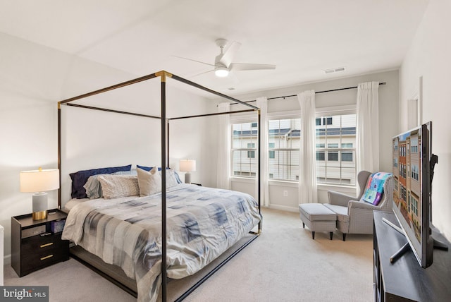 bedroom with carpet, visible vents, and ceiling fan
