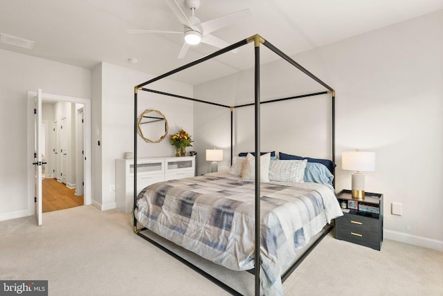 carpeted bedroom with ceiling fan, baseboards, and visible vents