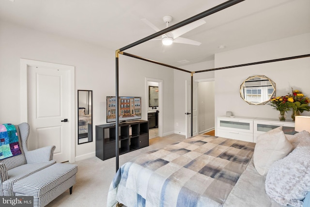bedroom featuring baseboards, connected bathroom, ceiling fan, and light carpet