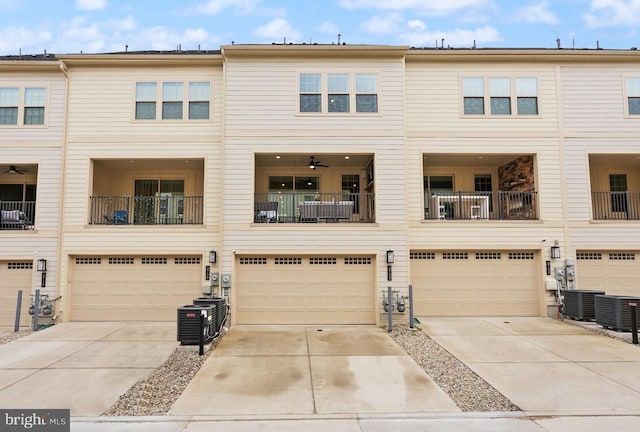 view of front of house with cooling unit, a garage, and driveway