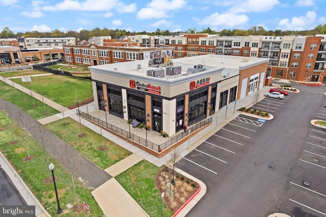 view of building exterior with uncovered parking