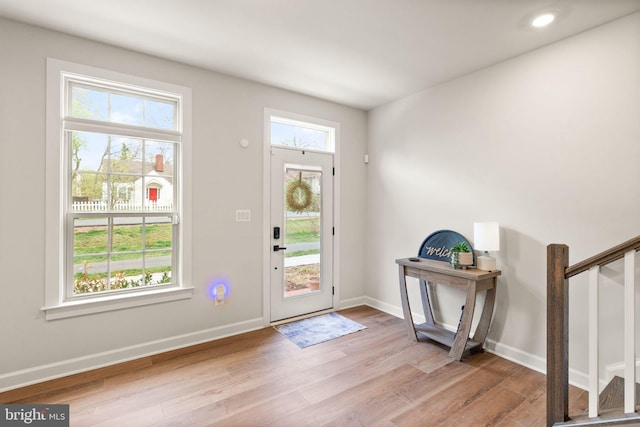 foyer entrance featuring wood finished floors, baseboards, and recessed lighting