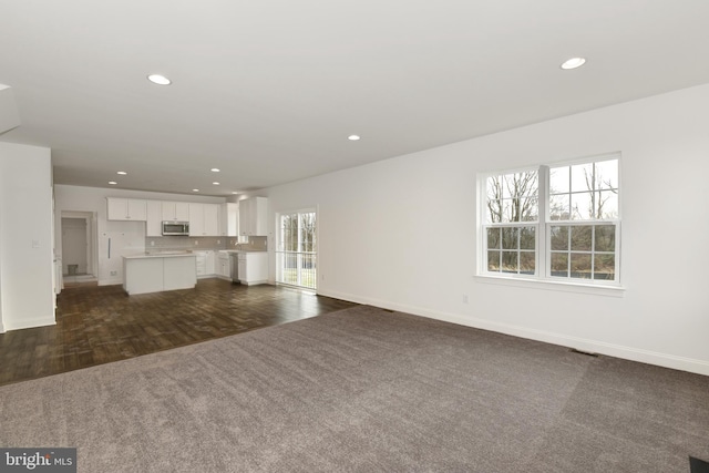 400 Rederick Ln Unit 2Oxford, Middletown, DE 19709 - unfurnished living room with dark carpet, baseboards, recessed lighting, and dark wood-style flooring
