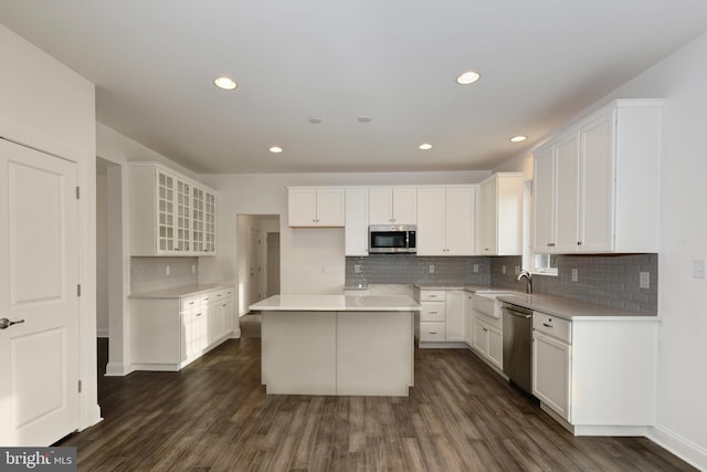 400 Rederick Ln Unit 2Oxford, Middletown, DE 19709 - kitchen featuring appliances with stainless steel finishes, dark wood-style floors, a center island, a sink, and backsplash