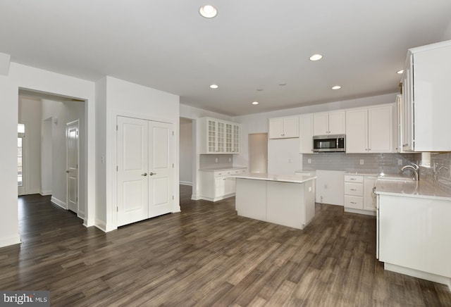 400 Rederick Ln Unit 2Oxford, Middletown, DE 19709 - kitchen featuring stainless steel microwave, dark wood-type flooring, a kitchen island, decorative backsplash, and recessed lighting