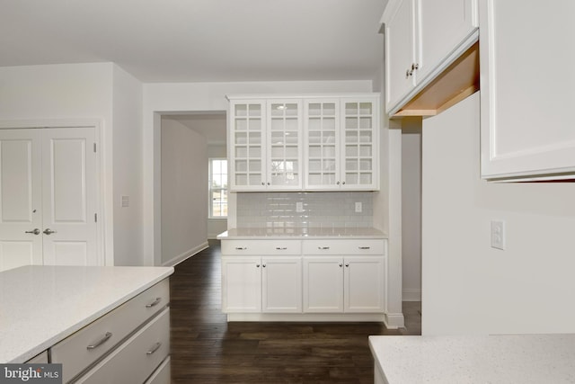 400 Rederick Ln Unit 2Oxford, Middletown, DE 19709 - kitchen with dark wood finished floors, backsplash, glass insert cabinets, white cabinets, and light stone counters