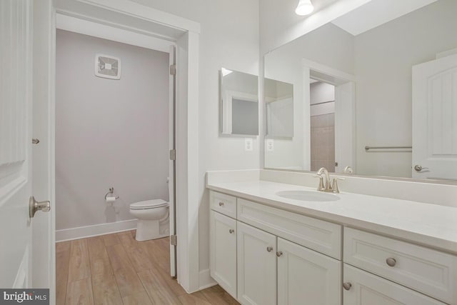 170 Harrier Way Unit 11, Chester, MD 21619 - bathroom featuring toilet, wood finished floors, vanity, and baseboards