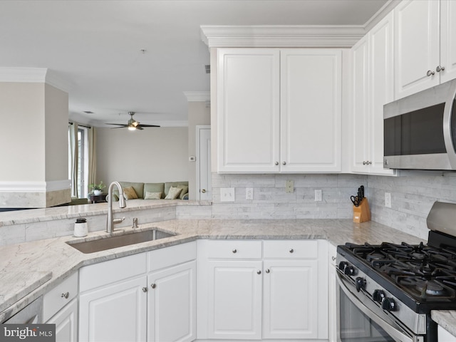 1909 Kenwood Ave Unit 303, Alexandria, VA 22302 - kitchen with a sink, a ceiling fan, crown molding, light stone countertops, and stainless steel appliances