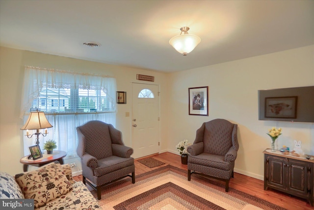 living room featuring baseboards and wood finished floors