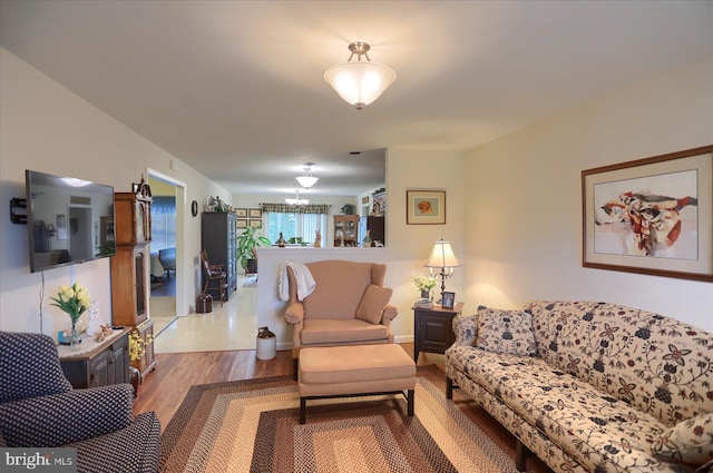 living room with a notable chandelier and wood finished floors