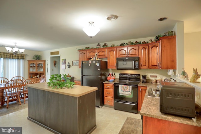 kitchen featuring brown cabinets, light countertops, black appliances, and a chandelier