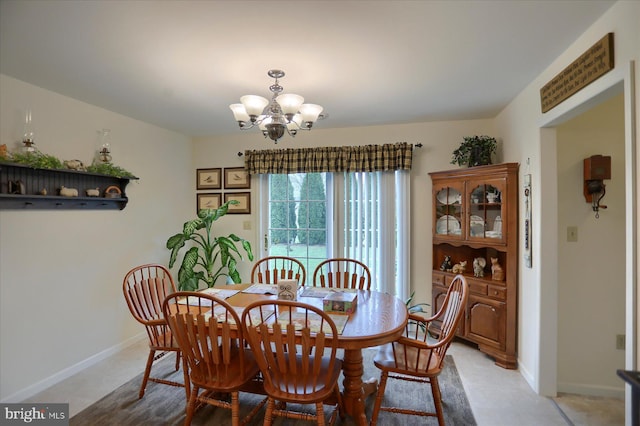 dining room with baseboards and a chandelier