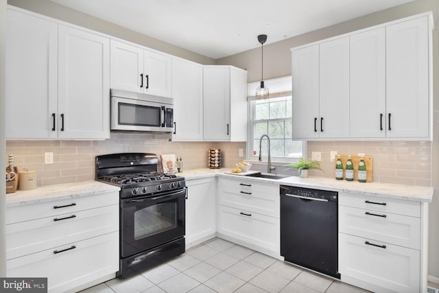 kitchen featuring decorative backsplash, a sink, white cabinetry, and black appliances