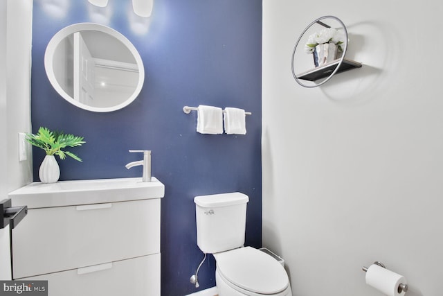 bathroom with toilet and baseboards