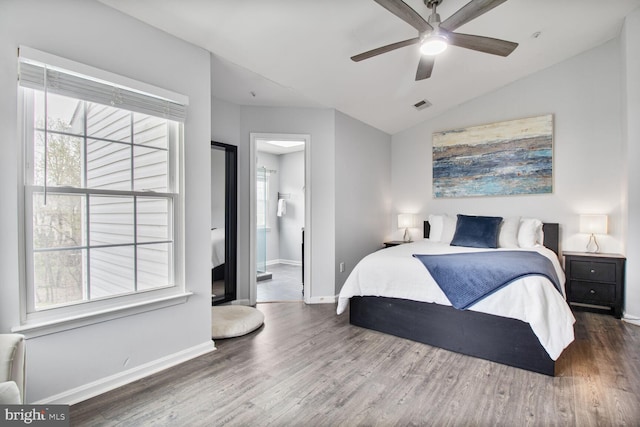 bedroom featuring wood finished floors, baseboards, and multiple windows