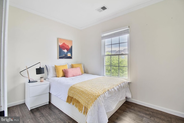 bedroom featuring visible vents, baseboards, crown molding, and dark wood finished floors