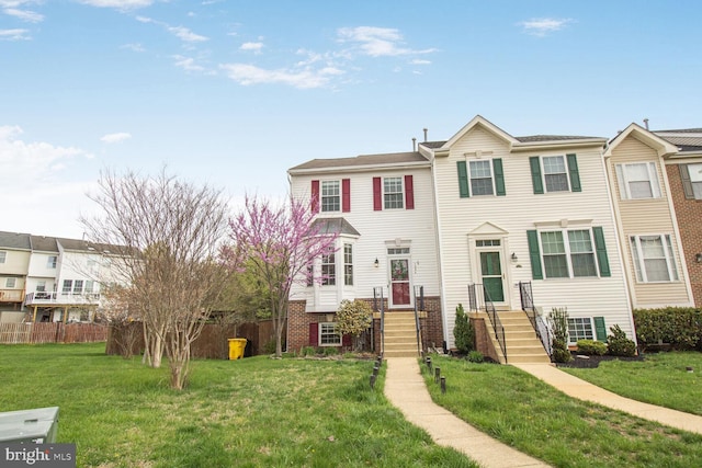 multi unit property with a front yard and fence
