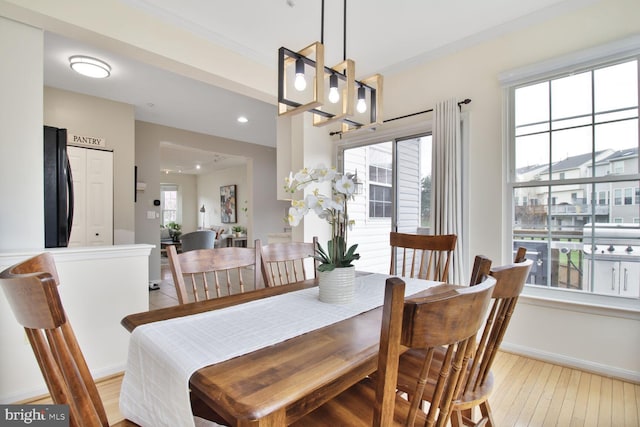 dining space with light wood-style floors, baseboards, and recessed lighting