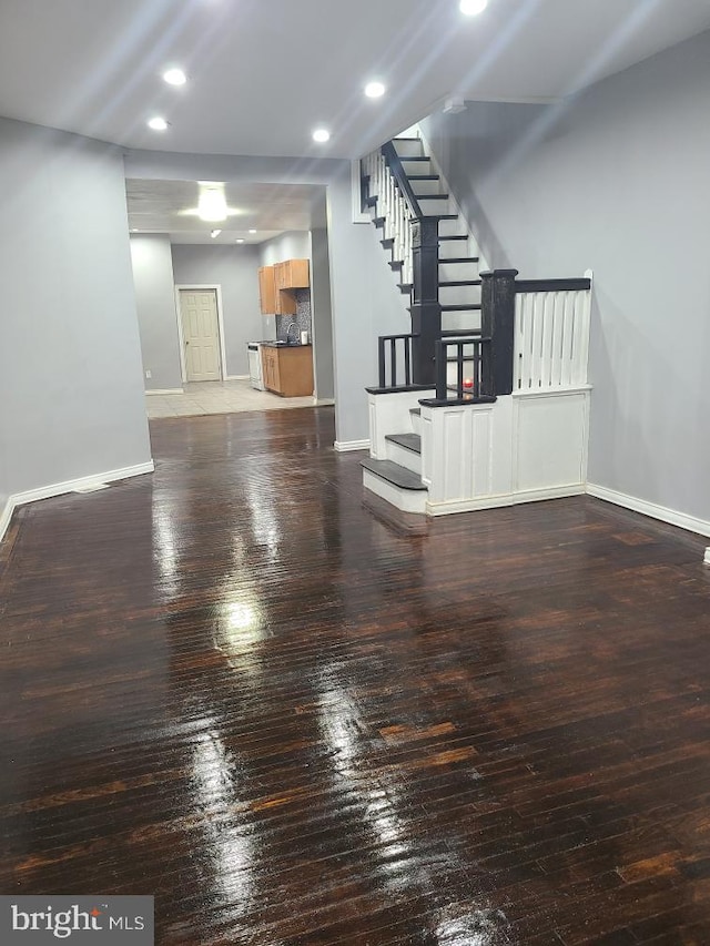 2321 W Lehigh Ave, Philadelphia, PA 19132 - unfurnished living room with stairs, baseboards, wood-type flooring, and recessed lighting